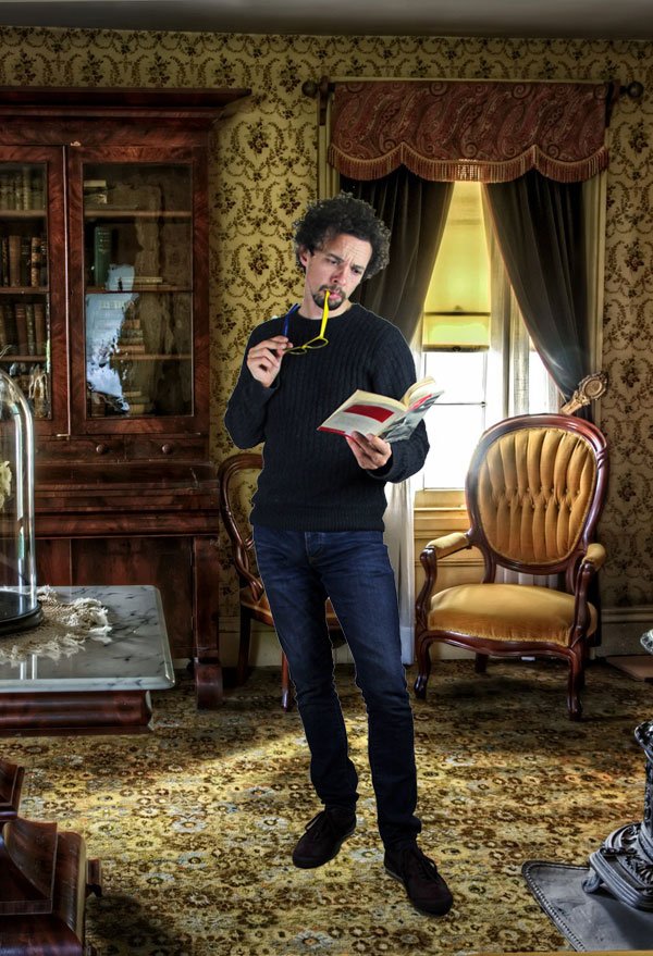 Comedian Elliot Mason reading a book in a thoughtful manner