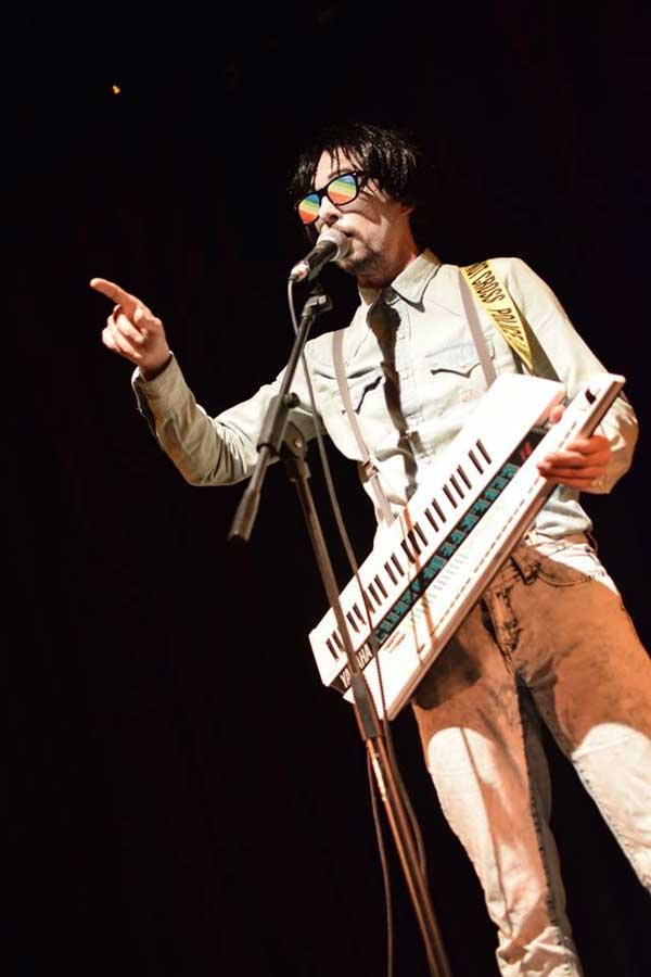 Elliot Mason dressed as an 80s electro person with a keytar at the Hundred Watt CLub. West End Centre, Aldershot. Photograph by Jennifer Marsden
