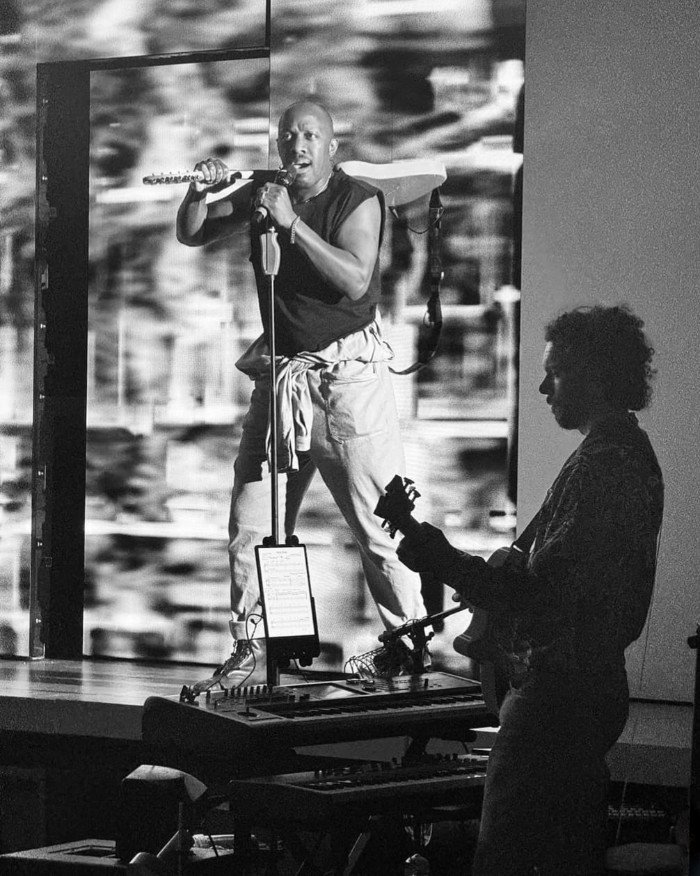 Elliot Mason playing guitar in Passing Strange