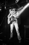 Musical comedian Elliot Mason playing guitar at the Fox & Firkin Lewisham 2010